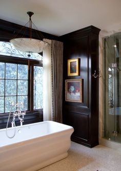 a bathroom with a tub, shower and window