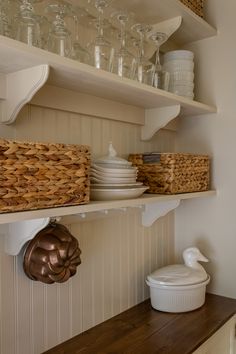 the shelves are filled with dishes and glasses