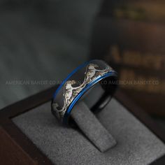 an image of a wedding ring with blue inlays