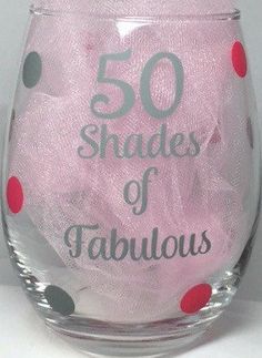 a wine glass that says 50 shades of fabulous