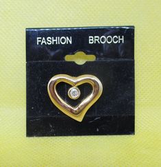 Never Worn vintage rhinestone gold tone metal open heart brooch. Length 15/16 inch. Width 1 inch. I offer multiple-item-order shipping charges. Heart Brooch, Plastic Jewelry, Brooch Vintage, Rhinestone Heart, Original Card, Cute Bracelets, Open Heart