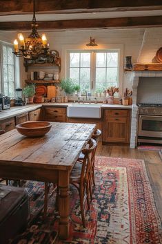 a kitchen with an old fashioned wooden table and rug on the floor in front of it