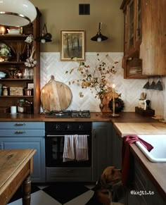 a kitchen with an oven, sink and wooden cabinets