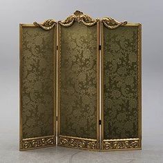 an ornately decorated room divider in gold