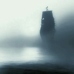 an old ship in the middle of foggy water