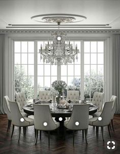 a dining room table with chairs and a chandelier