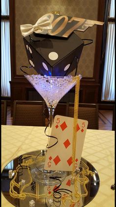 a table topped with a martini glass filled with cards