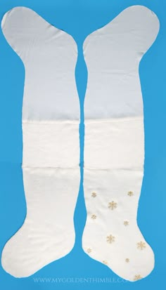 two white stockings with gold snowflakes on them