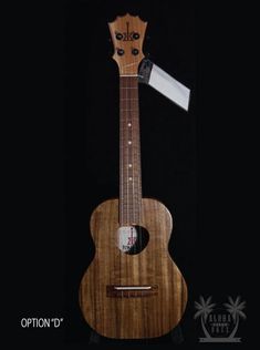 the ukulele is made out of wood and has a white label on it