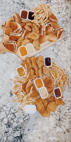 two trays filled with french fries and ketchup on top of a table