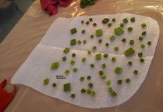 chopped up green vegetables on a piece of white paper