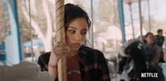 a girl holding onto a rope on a merry go round