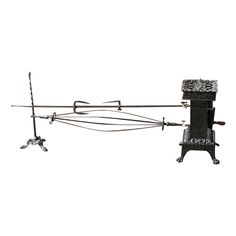 an old fashioned stove with four burners and two tongs on the top, against a white background