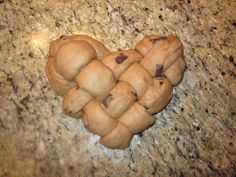 a heart shaped cookie sitting on top of a counter