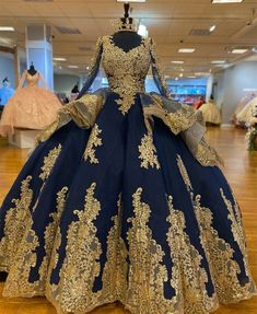 a blue and gold ball gown on display in a store