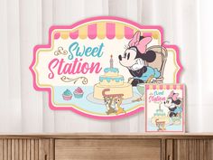 there is a sign that says sweet station and a cake with minnie mouse on it