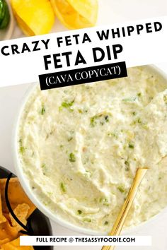 a white bowl filled with feta dip next to chips