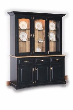 a black china cabinet with glass doors and plates