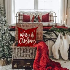 a christmas themed bedroom with red and white pillows