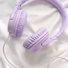 a pair of headphones sitting on top of a bed