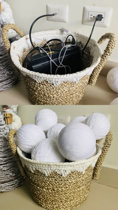 two baskets filled with white balls sitting on top of a table next to an electrical outlet