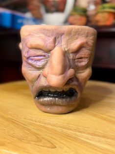 an old man's face is sitting on a table