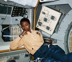 a woman is sitting in the space station