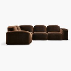 a brown couch sitting on top of a white floor