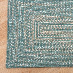 a blue and white rug on top of a wooden floor