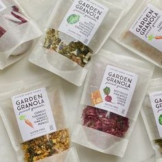 six bags of garden granola sitting on top of a table next to each other