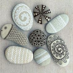 some rocks with designs on them are arranged in a circle and placed next to each other