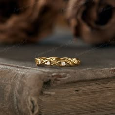 a close up of a gold ring on top of a book