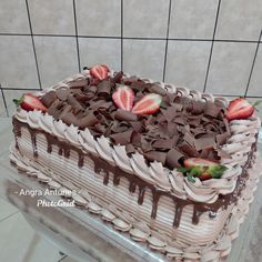 a cake with chocolate icing and strawberries on top