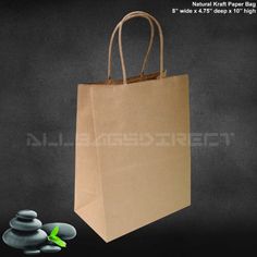 a brown paper bag sitting on top of a pile of rocks next to a black background