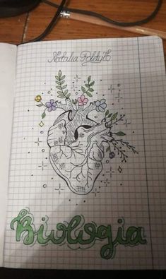 a notebook with a drawing of a heart and flowers on it