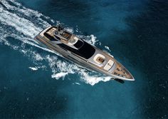 an aerial view of a motor boat in the middle of the ocean, taken from above