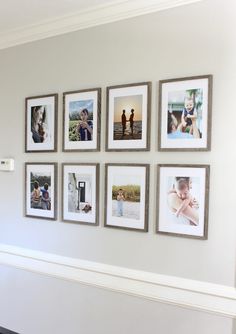 a wall with many pictures hanging on it