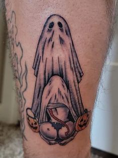 a man's leg with a ghost on it and pumpkins around the legs