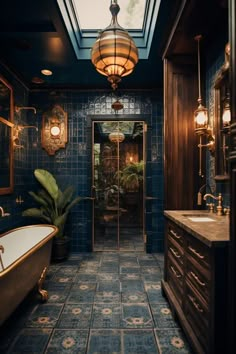 a bath room with a tub a sink and a light hanging from the skylight