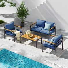 an outdoor patio furniture set with blue cushions next to a swimming pool and potted plant