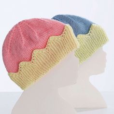 two knitted hats on top of each other in front of a white mannequin head