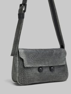 Trunkaroo Soft shoulder bag made of crocodile print leather with a hand-buffed vintage effect. Medium size. The rectangular shape features a front flap closed via a large magnetic clasp engraved with the Marni logo and two half spheres covered in tonal leather. Nappa lining with single pocket. Adjustable leather strap with tonal buckle. Flat Heel Boots, Vintage Effect, Crocodile Print, Lacing Sneakers, Boot Accessories, Denim Bag, Bag Dress, Cool Socks, Magnetic Clasp