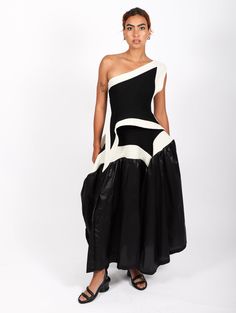 Crafted from recycled polyester, the Square Scheme Skirt from Issey Miyake is a stylish and sustainable piece. Its unique triangular silhouette features contrasting knit and woven fabrics to create three-dimensional shapes. A special slim waistline and structured bustle offers a flattering fit with a stand-out effect. Cheyenne is 5'7" and a size 2 wearing Issey Miyake's One Size. Garments from Issey Miyake's collection are available in one size only. This size fits a variety of sizes, this style sizes 2-16. Dimensional Shapes, Three Dimensional Shapes, Fashion Forecasting, Woven Fabrics, How To Make Clothes, Bandeau Top, Fall 2023, Issey Miyake, Shoe Store