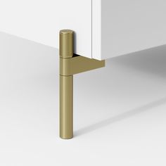 a close up of a door handle on a white cabinet with a gold colored handle