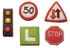 some cookies are decorated to look like traffic signs and stoplights, including one with the letter l