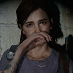 the last of us's character is looking into the camera with her hand on her mouth