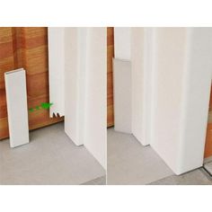 there are two tall white poles next to each other on the floor in front of a wood paneled wall