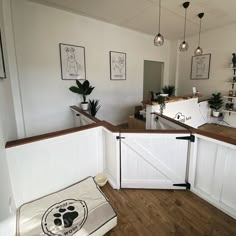 a dog bed in the corner of a room with white walls and wood flooring