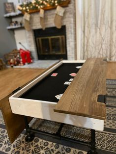 a pool table in the middle of a living room with a christmas tree behind it