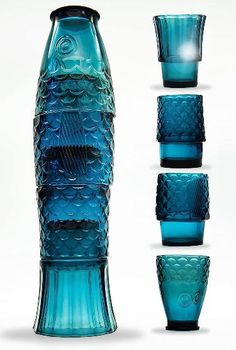 four blue glass vases with different shapes and sizes in front of each other on a white background